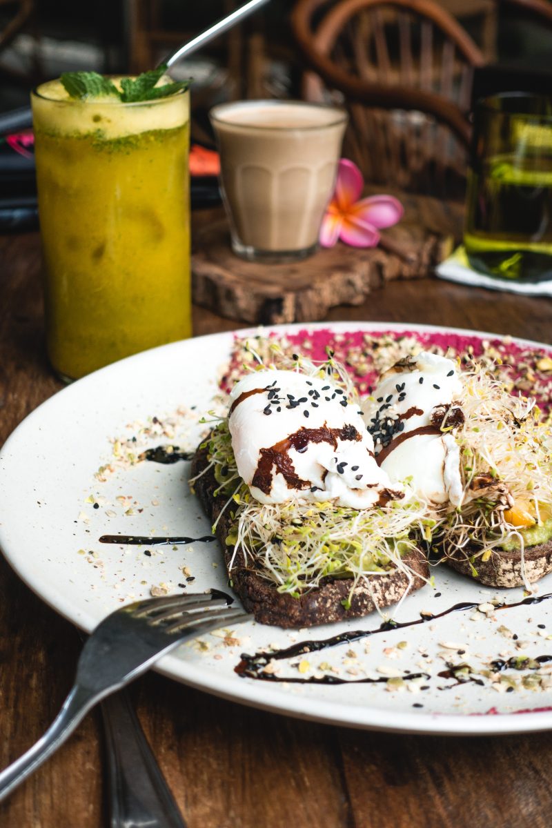 Breakfast sandwich with poached eggs and sprouts