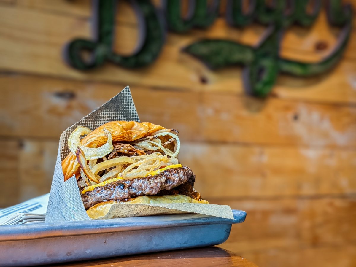 Cheese burger with fried onion on a tray