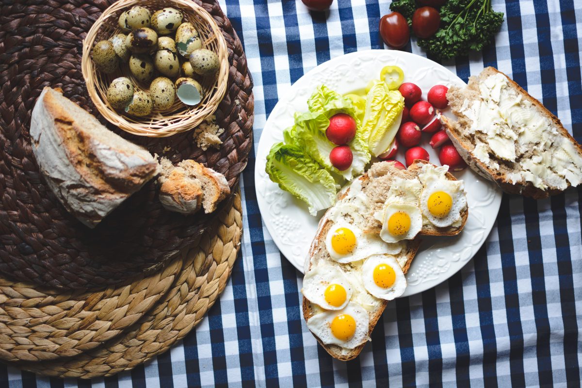 Easter breakfast of fried quail eggs on bread with butter