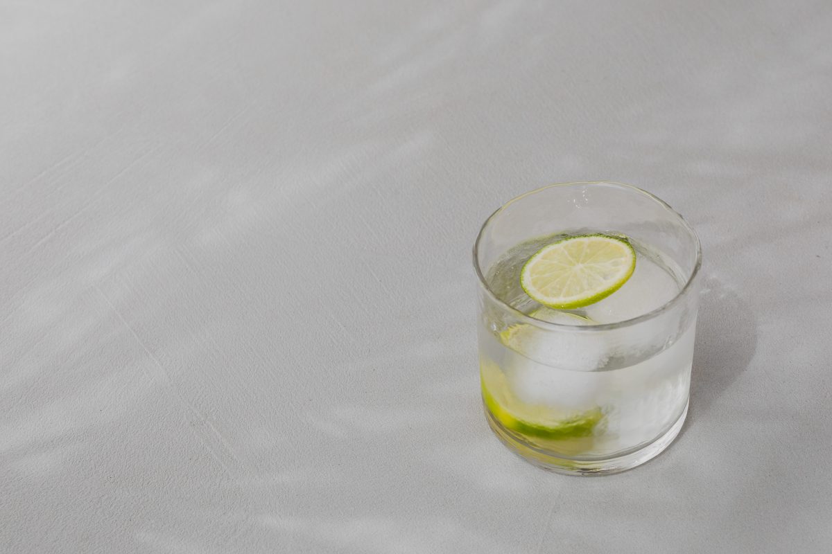 Glass of water with slice of lime and ice