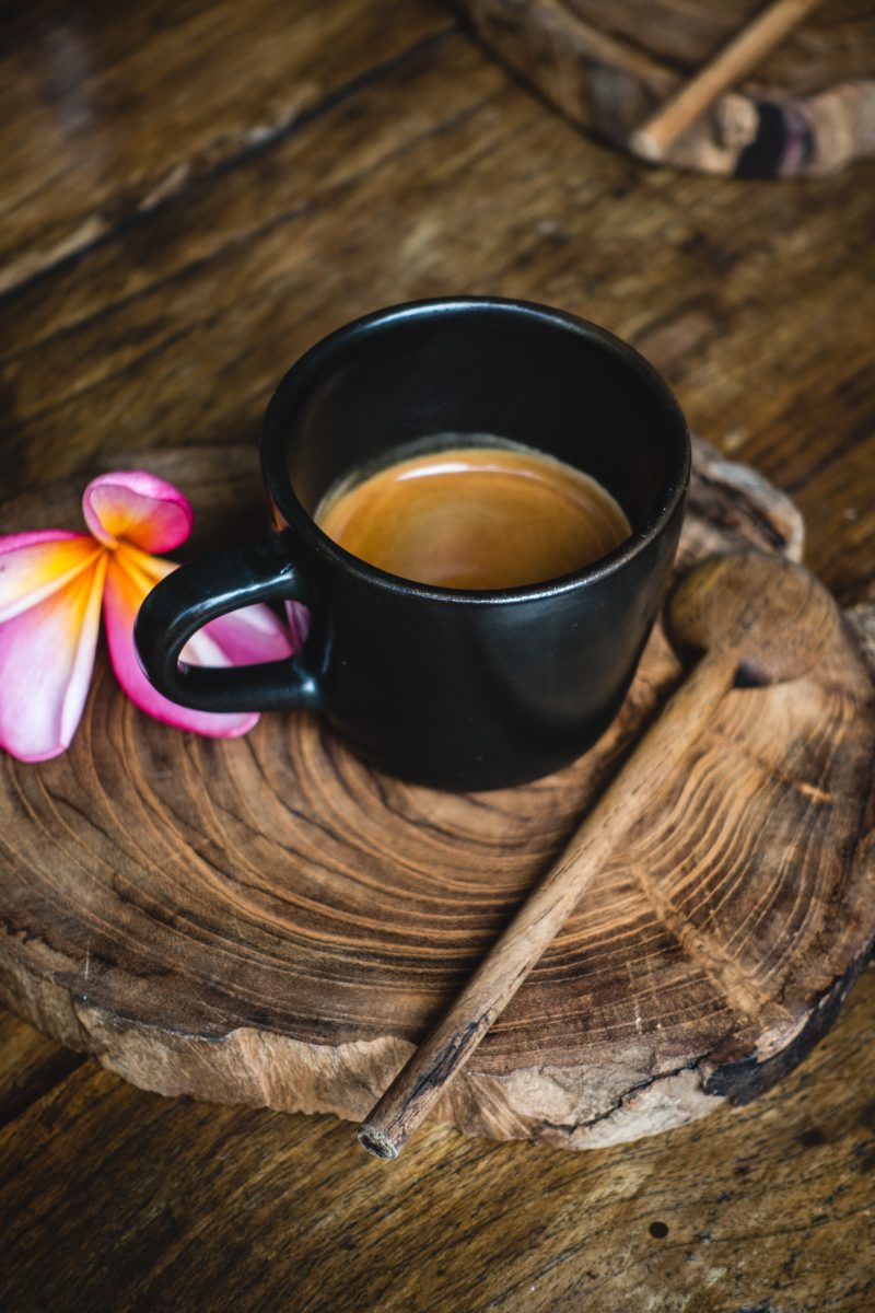 Small black cup with espresso coffee