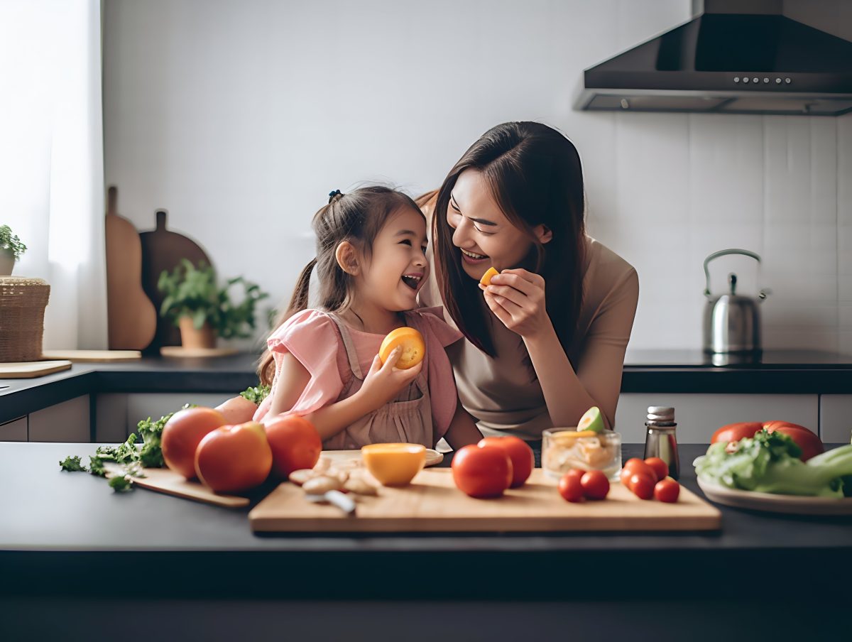 Woman playing with her  daughter in the kitchen